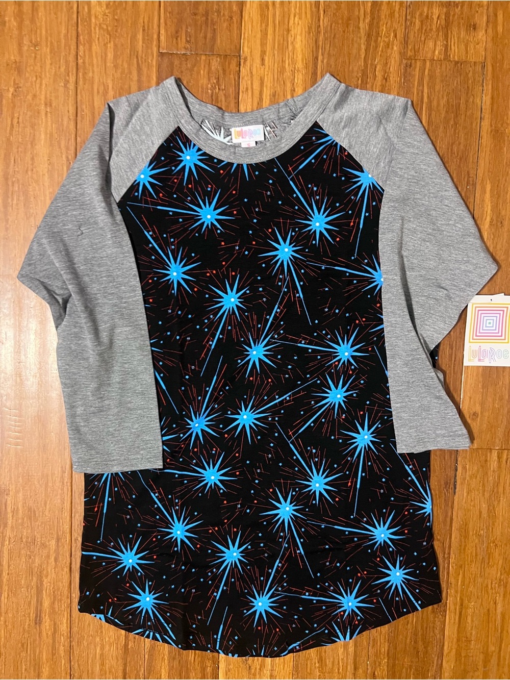 LuLaRoe Randy Top - Black & Gray with Bright Blue Starburst Print